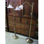 A contemporary brass two branch standard lamp with crimped glass shades and foliate detail