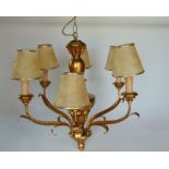 A gilt wood six branch ceiling light with scrolled metal leaf decoration.