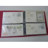 Three albums containing a large quantity of FDCs and three pages of mixed worldwide stamps