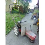 A petrol driven single axle rotary strimmer with Briggs & Stratton engine.