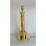 An Arts & Crafts brass table lamp in the form of a column, 38 cm high approx.