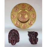 A large eastern gilt brass charger decorated in relief with copper panels of Buddhistic deities,