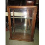 An oak counter top display cabinet with glazed panel sides and plate glass shelves, together with