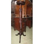 Mahogany torchere with spiral twist column and tripod base.