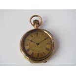 A continental 10ct fob watch, the case engraved with scrolled foliage, 34.6 grams (including