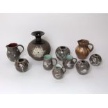 A collection of nine pieces of Fishley Holland pottery wares including a jug with triple spotted