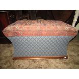 A vintage ottoman of rectangular form with concave sides, carpet top and bun feet.