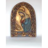 An antique style embossed arched plaque of Mary Magdalene with child amidst an arched frame of