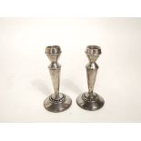 A pair of silver candlesticks with inlaid tortoiseshell stepped circular bases, 14 cm high