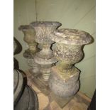 Six similar small weathered marble urns, one with stepped square cut platform base.