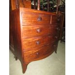 A Georgian mahogany bow fronted chest of three long and two short drawers with caddy top raided on