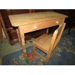 A stripped pine side table with frieze drawer on turned supports together with a further primitive