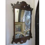 A Georgian style mirror, the figured and burr walnut frame with fret carved outline