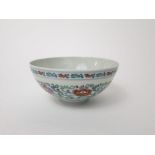 A Chinese Doucai type bowl with polychrome painted and scrolling leaf and floral detail and with