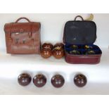 Two bags containing a collection of lawn bowls together with an alabaster lamp.