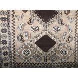 A Persian style floral runner decorated with brown medallions and flowerheads upon a fawn ground,