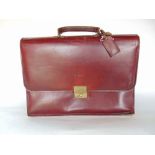 An oxblood leather Swaine Adeney Brigg of London briefcase with segmented interior.