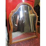 A Victorian wall mirror of shield shaped form with moulded frame