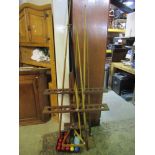 A cue rack, a number of snooker cues, balls, triangle, brush, etc