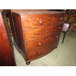 A mid 19th century mahogany bow fronted chest with three long and two short drawers on turned