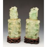 A pair of Chinese carved green rock crystal lidded vases detailing pheasants, foliage etc on