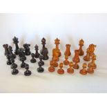 A boxwood and rosewood chess set in the Staunton manner within a games box.