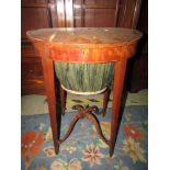 Early 19th century mahogany ladies sewing table of oval form with pleated basket raised on four