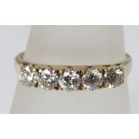 A five stone diamond ring marked 18k, size L/M, 2g