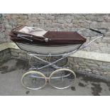 A vintage coach built pram by Marmet with sprung chromium plated frame and under tray