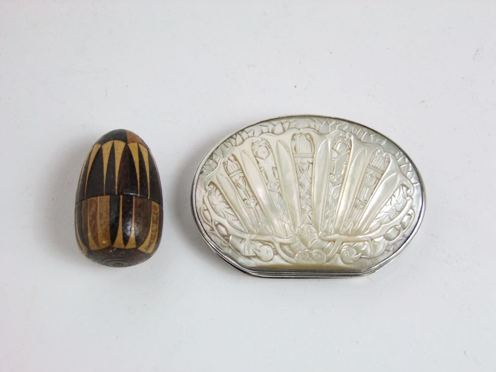 A 19th century continental white metal and mother-of-pearl inlaid snuff box with carved detail
