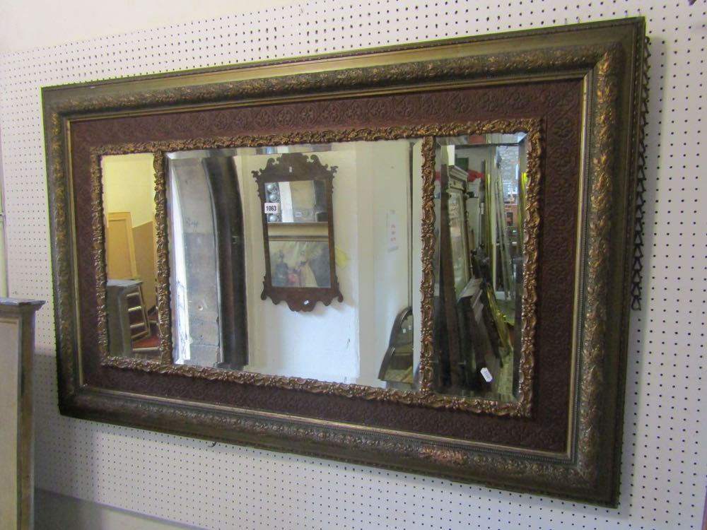 A wall mirror of rectangular form stepped and moulded frame with oak leaf and acorn detail