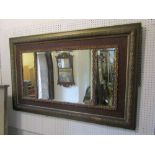 A wall mirror of rectangular form stepped and moulded frame with oak leaf and acorn detail