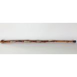 An interesting walking stick carved from a hollow branch, fitted with an ivory snake chasing a