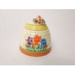 A Clarrice Cliff honey pot and cover and cover in the form of a bee skep with painted crocus