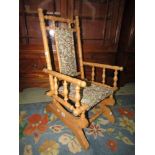 An American rocking chair unusually in beechwood and of child's size with carpet type seat and