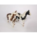 Two Beswick models of standing ponies, one in the skewbald colourway, the other in a piebald