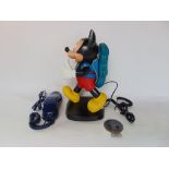 A novelty Disney walking Mickey Mouse home telephone together with a further phone and a St