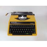 A vintage 'Silver-reed Silverette' cased typewriter in yellow, together with a box "brownie" camera