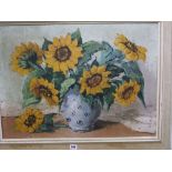 A mid 20th century oil on canvas, still life with sunflowers in a spotted jug, 50cm x 70cm, framed