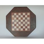 An inlaid marble checker board the octagonal piece with moulded borders 40 x 40 cm approx.