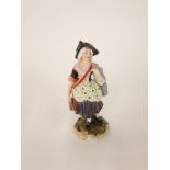 A 19th century Derby figure of a seamstress in 18th century style costume carrying a pair of