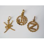 Three gold pendants, two eastern character examples in 21ct gold, and one other. Together with two