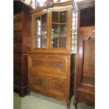 19th century oak side cupboard, the lower section enclosed by two carved and panelled doors and fall