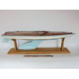 A good scratch built pond yacht with sky blue painted vessel upon an oak stand, 103 cm long approx.