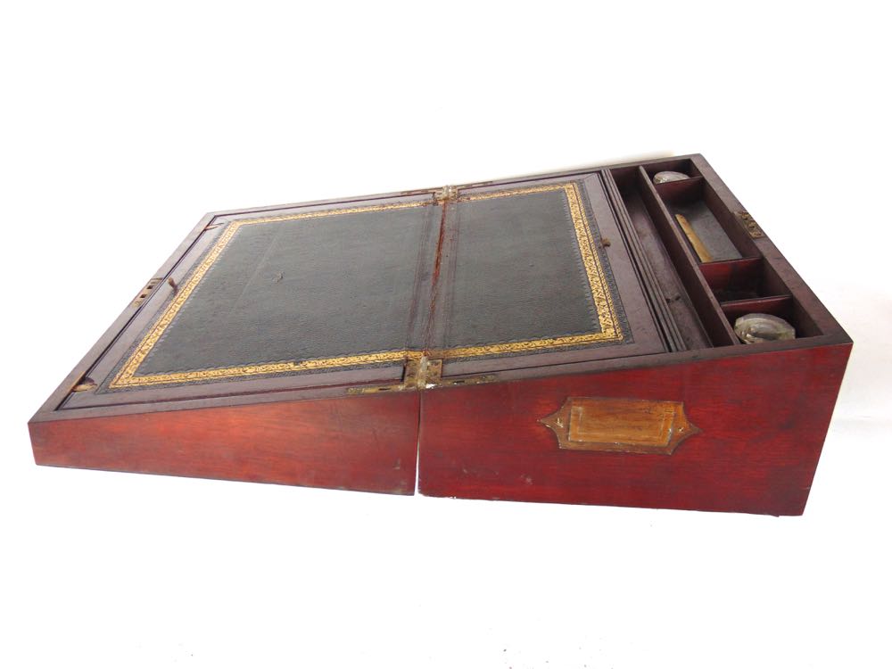 A 19th century mahogany cased writing slope with gilt tooled black leather and fitted interior, 46