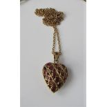 A 9ct gold necklace with heart shaped hollow pendant, with four diagonal rows of semi-precious