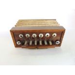 A 19th century rosewood squeeze box of rectangular form fitted with mother of pearl batons, 20 cm