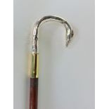 A slim walking stick with silver swans head, dated London 1915, fitted with ball glass eyes.