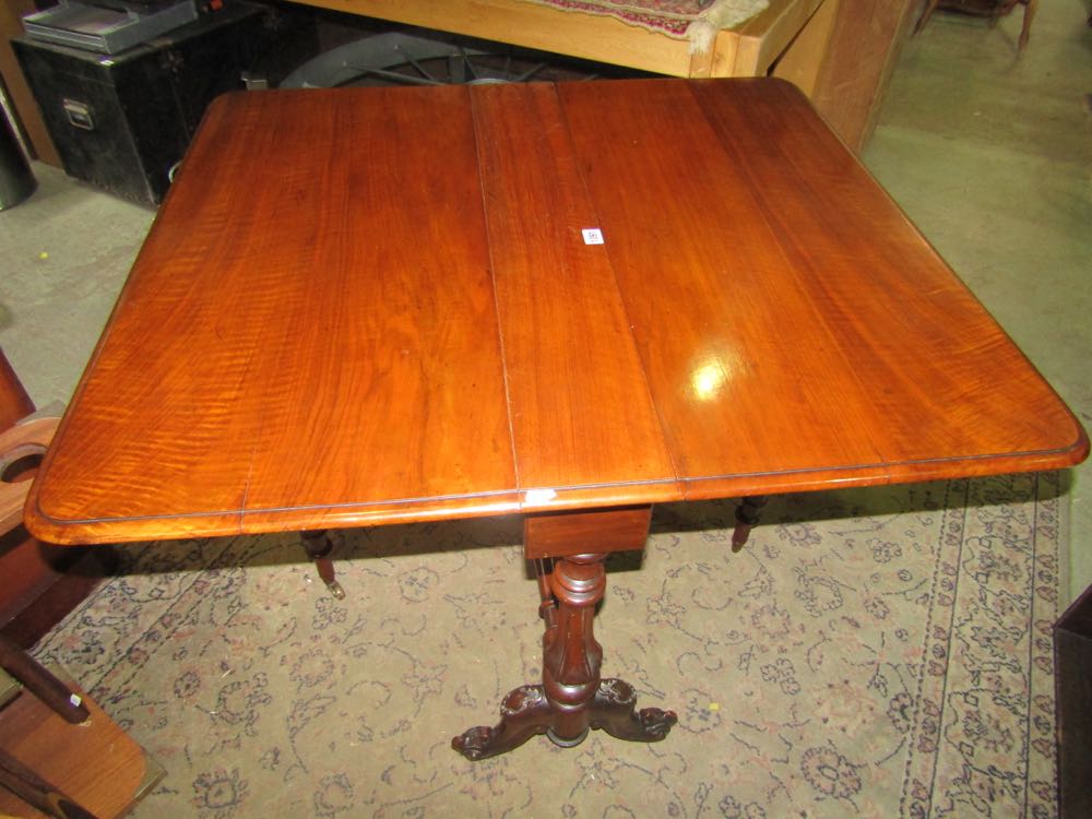 A Victorian walnut sutherland tea table of usual form raised on turned and fluted supports and feet - Image 2 of 2