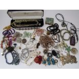 A mixed lot of costume jewellery to include a number of faceted bead necklaces and a 9ct gold